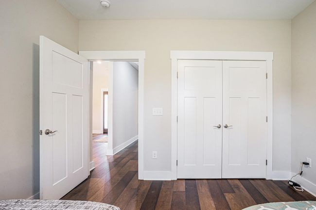 Unfurnished bedroom with dark wood-style flooring and a closet | Image 22