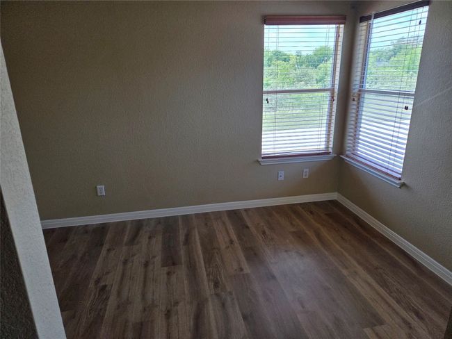Empty room featuring dark wood-style floors and baseboards | Image 32