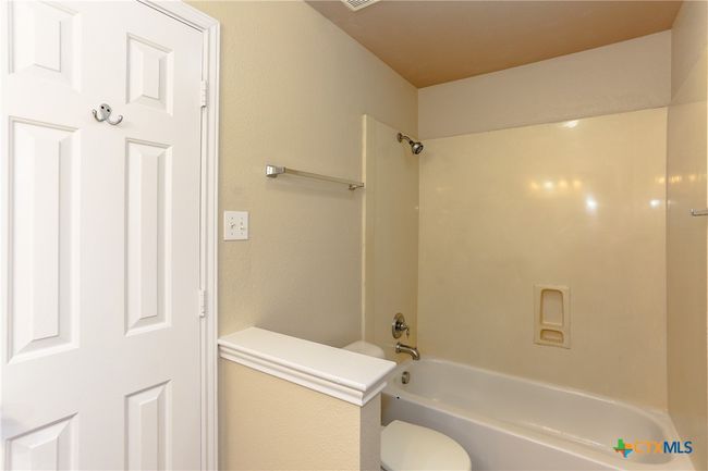 Jack and Jill style bathroom with the two hallways gives this home an interesting floorplan | Image 22