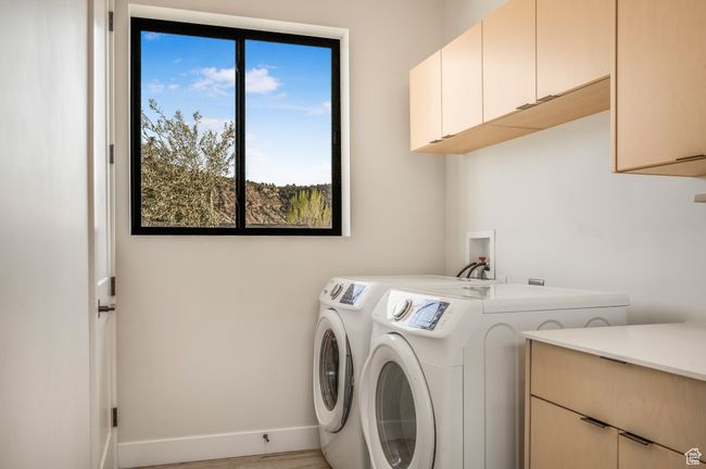 Laundry room with independent washer and dryer, baseboards, and cabinet space | Image 39