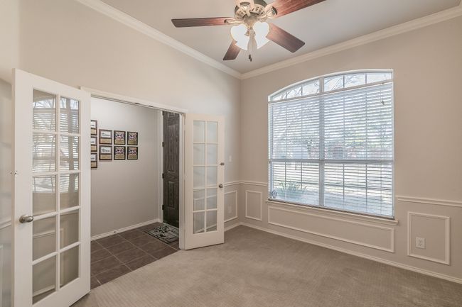 Flex space-Office featuring crown molding, ceiling fan, french doors, and a decorative wall | Image 18