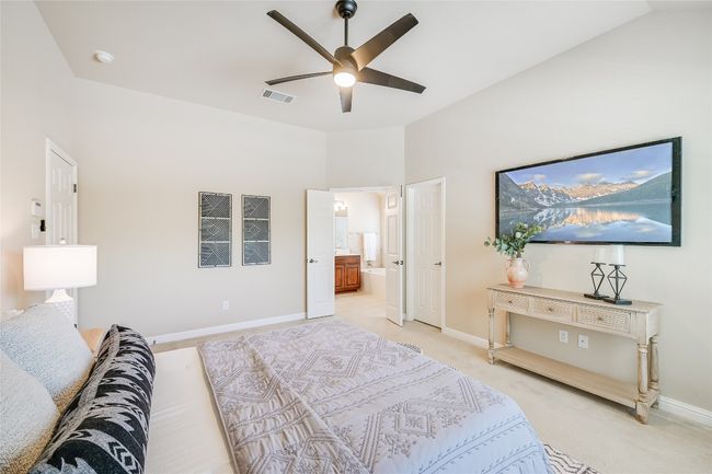 Bedroom featuring light carpet, ensuite bath, and ceiling fan | Image 15