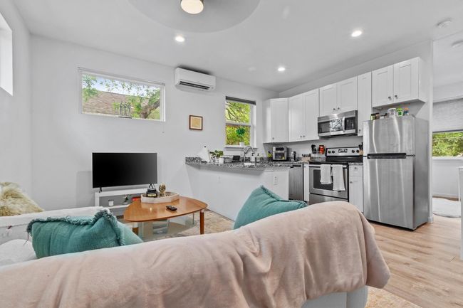 CASITA ADU: Living area with a mini-split, recessed lighting, light floors, and a wealth of natural light | Image 31
