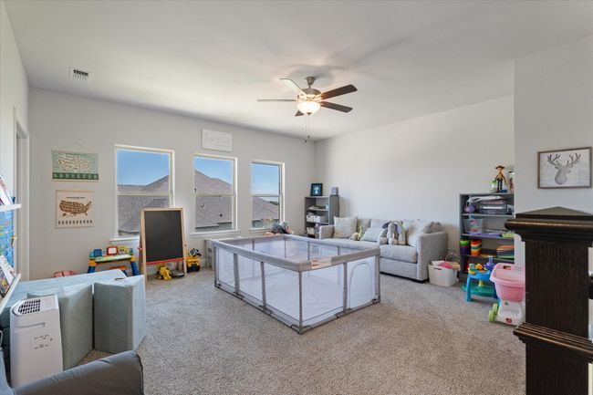 Living room with carpet flooring and a ceiling fan | Image 27