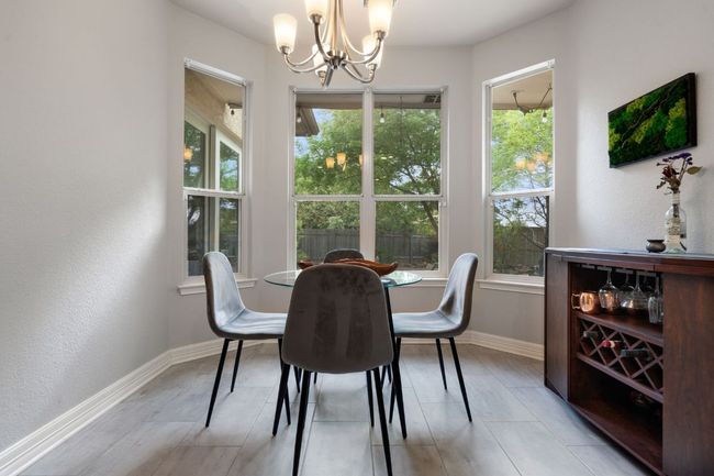 Dining room featuring baseboards and an inviting chandelier | Image 19