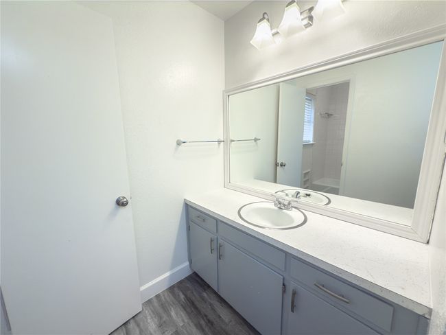 Bathroom with hardwood / wood-style flooring and vanity | Image 12