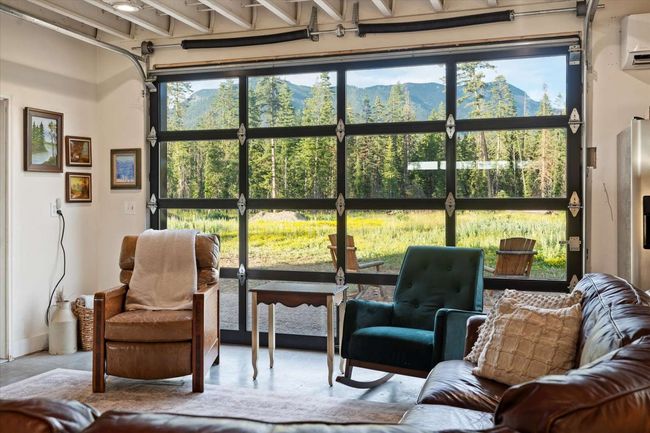 Sunroom featuring a mountain view and beam ceiling | Image 17