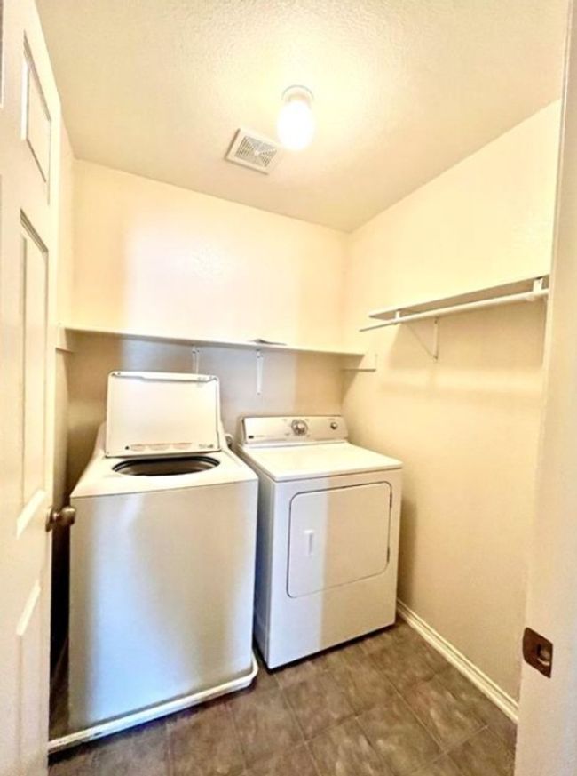 Laundry room featuring washer and clothes dryer and baseboards | Image 16
