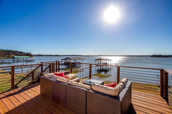 Wooden terrace with an outdoor hangout area and a water view | Image 6