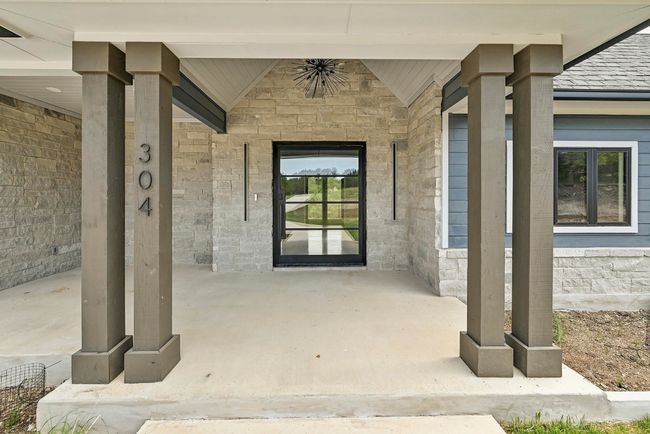 A striking pillared front porch welcomes you home. | Image 8