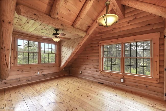 Second floor primary bedroom, ceiling fan and light fixture, front and side windows | Image 23
