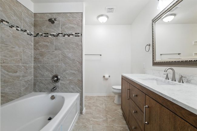 Bathroom featuring vanity and shower / bath combination | Image 20