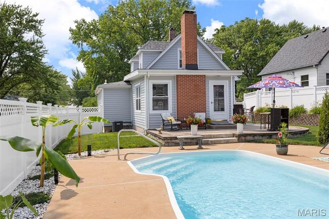 View of swimming pool featuring a patio and a fenced backyard | Image 40