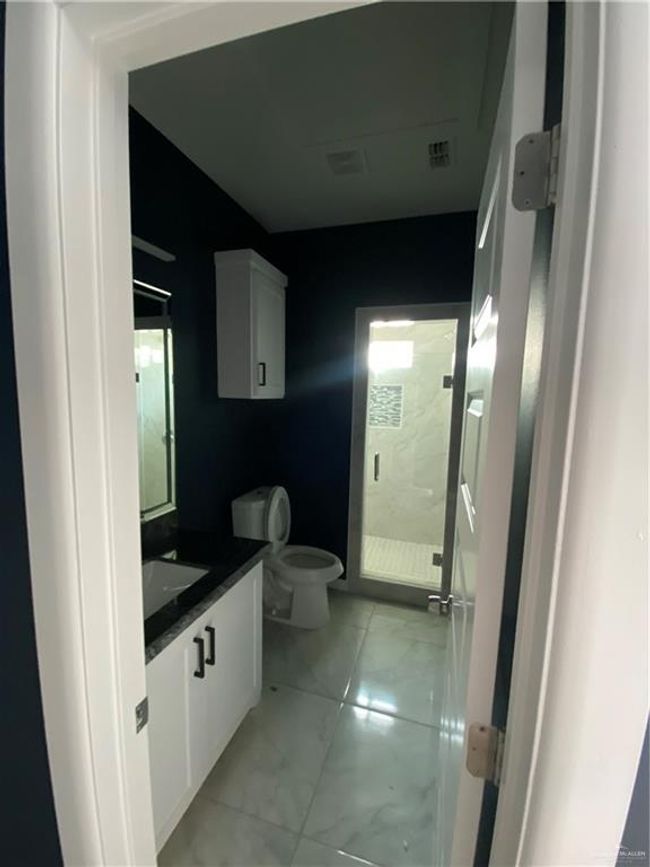 Bathroom with vanity, a shower stall, and marble finish flooring | Image 8
