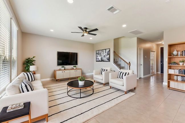 Living area with recessed lighting, baseboards, ceiling fan, and visible vents | Image 10
