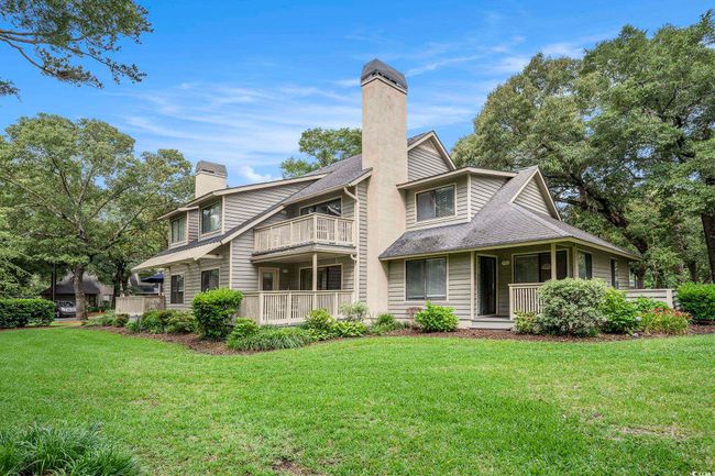 Back of house featuring a chimney, a balcony, and a lawn | Image 25