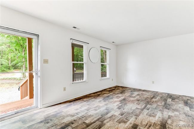 Spare room with wood finished floors and healthy amount of natural light | Image 9