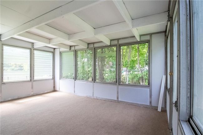 Unfurnished sunroom with beam ceiling | Image 15
