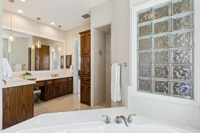 Another view of the generous vanity space in the primary bathroom. | Image 18