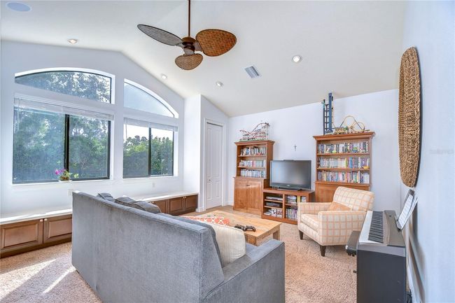 Bask in the serene ambiance, boasting large arched windows that bathe the room in natural light and offer tranquil views of lush greenery. | Image 17