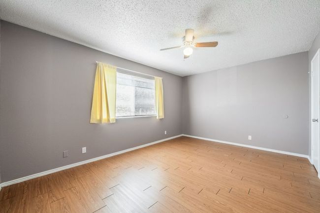 Unfurnished room with ceiling fan, a textured ceiling, and light wood-style floors | Image 20