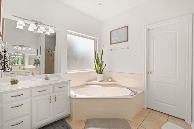 Primary bathroom with separate sinks, garden tub and separate walk in shower and walk in closet | Image 21