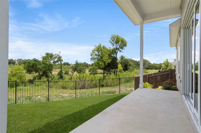 Fenced backyard with a patio | Image 33