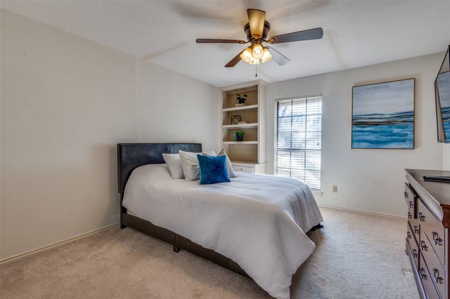 Bedroom featuring light colored carpet, a textured ceiling, and baseboards | Image 27