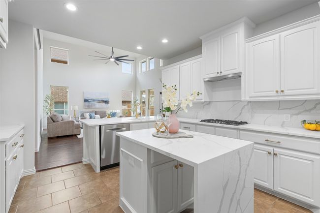 Kitchen featuring recessed lighting, dishwasher, gas stovetop, a center island, and a ceiling fan | Image 6