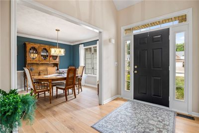 Entryway with crown molding, a healthy amount of sunlight, and light hardwood / wood-style flooring | Image 3