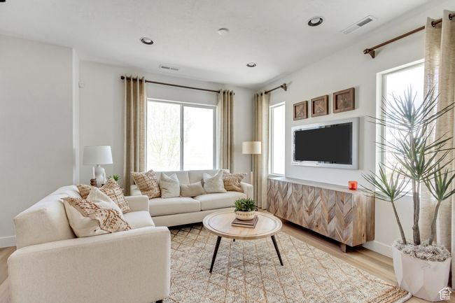 Living room with light wood-style floors and recessed lighting | Image 30