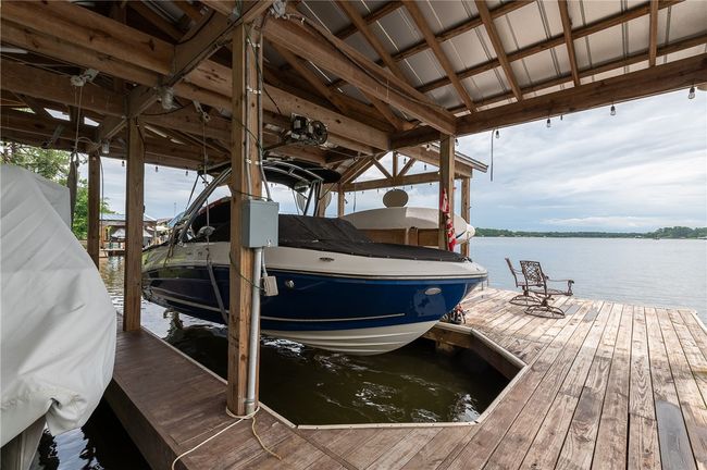 Dock area with boat lift and a water view | Image 14