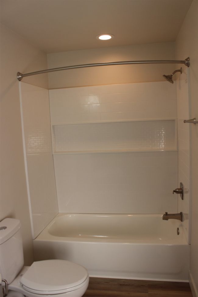 Full bath with wood finished floors, bathing tub / shower combination, and recessed lighting | Image 15