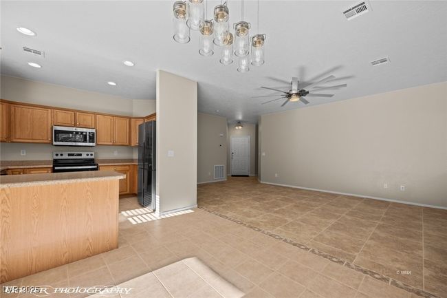 Kitchen featuring light countertops, appliances with stainless steel finishes, and visible vents | Image 9