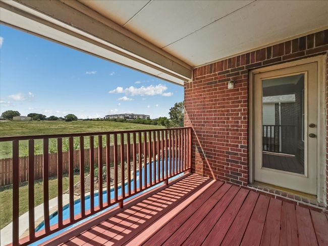 View of balcony overlooking the pool. | Image 24