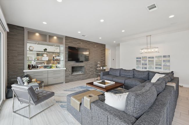Living area with visible vents, recessed lighting, a notable chandelier, and a fireplace | Image 22