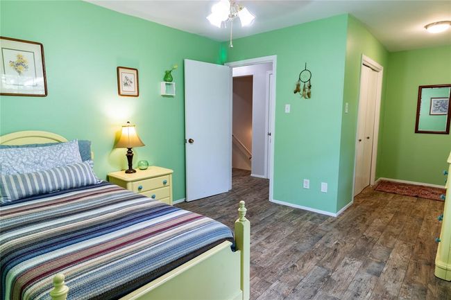 Upstairs bedroom (three of three) with alcove to the right providing access to balcony. | Image 24
