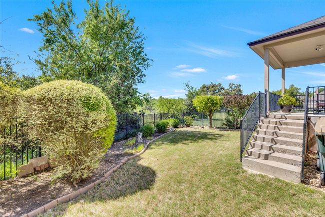 View of back yard with a stairway to enter patio and back door | Image 30