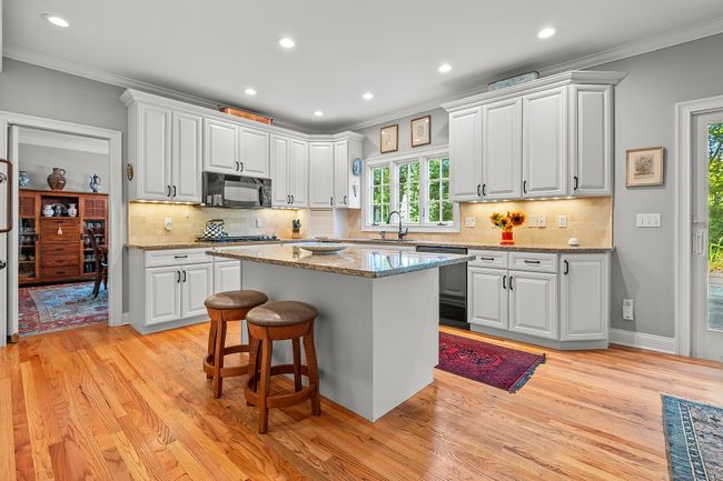 Large eat-in kitchen that flows to the family room and also leads too the patio and pool. | Image 13