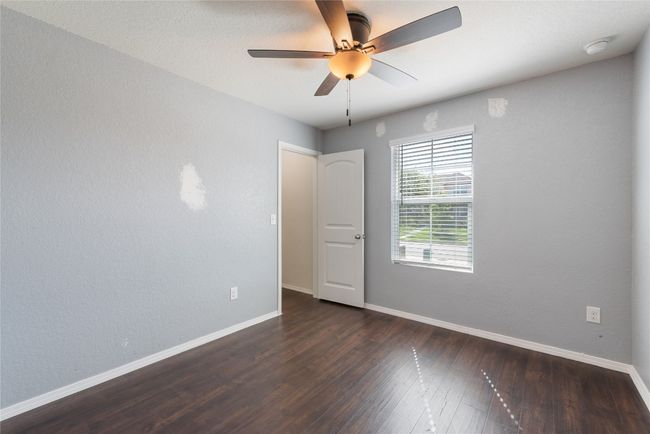 Empty room featuring dark wood-type flooring and ceiling fan | Image 16