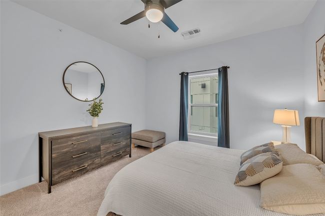 Bedroom with light colored carpet and a ceiling fan | Image 18
