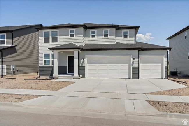 View of front of house featuring driveway, an attached garage, and a shingled roof | Image 4