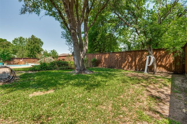 View of yard opposite the pool that is a great space for a play yard | Image 36