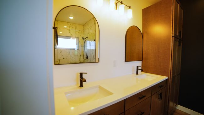 Bathroom featuring double vanity and a shower | Image 34