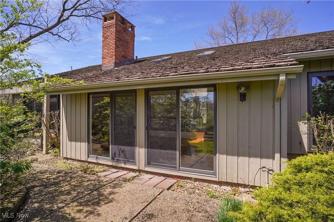 Rear view of house with a patio area and a chimney | Image 46
