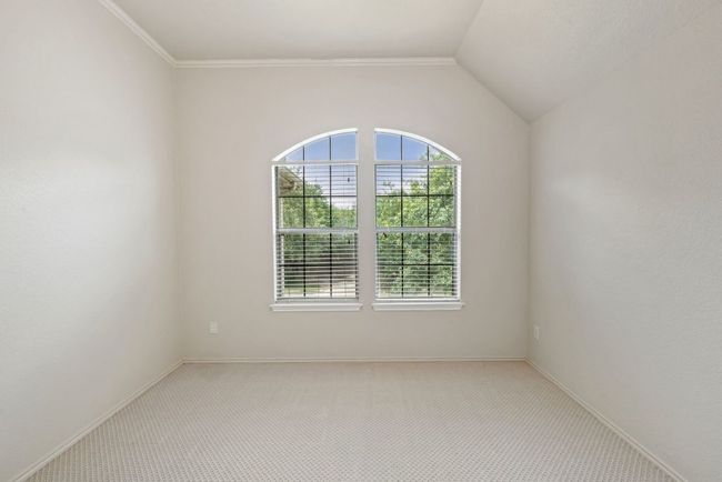 Carpeted spare room featuring vaulted ceiling and baseboards | Image 21