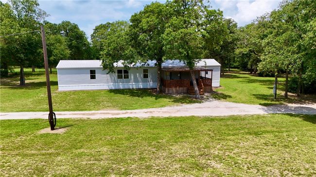 Manufactured / mobile home featuring a front yard and a metal roof | Image 4