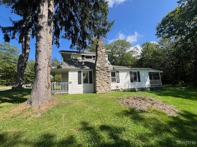 Side of House, Showing Stone Chimney and Front and Back Covered Porches and Balcony | Image 3