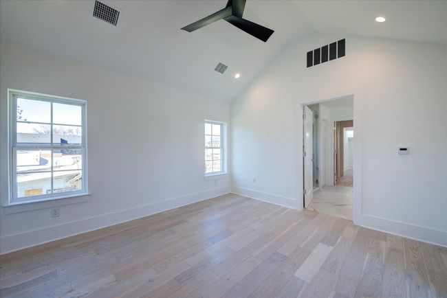 As with the rest of the home, the primary bedroom gets tons of natural light. The primary en suite bathroom connects the bedroom to a spacious walk-in closet and additional flex room that could be used as an office, studio or even more closet space. | Image 22