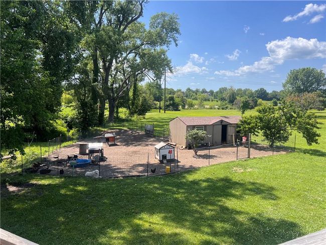 View of yard with an outbuilding and view of wooded area | Image 41